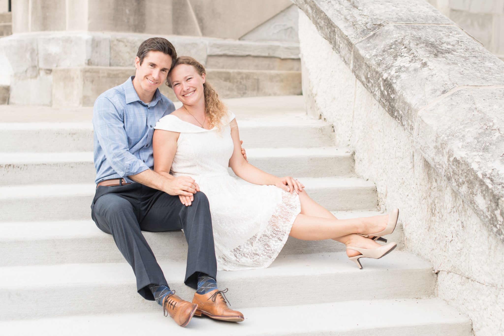 Couple sitting on steps of historic building during photo session by Indianapolis wedding photographer Victoria Rayburn Photography
