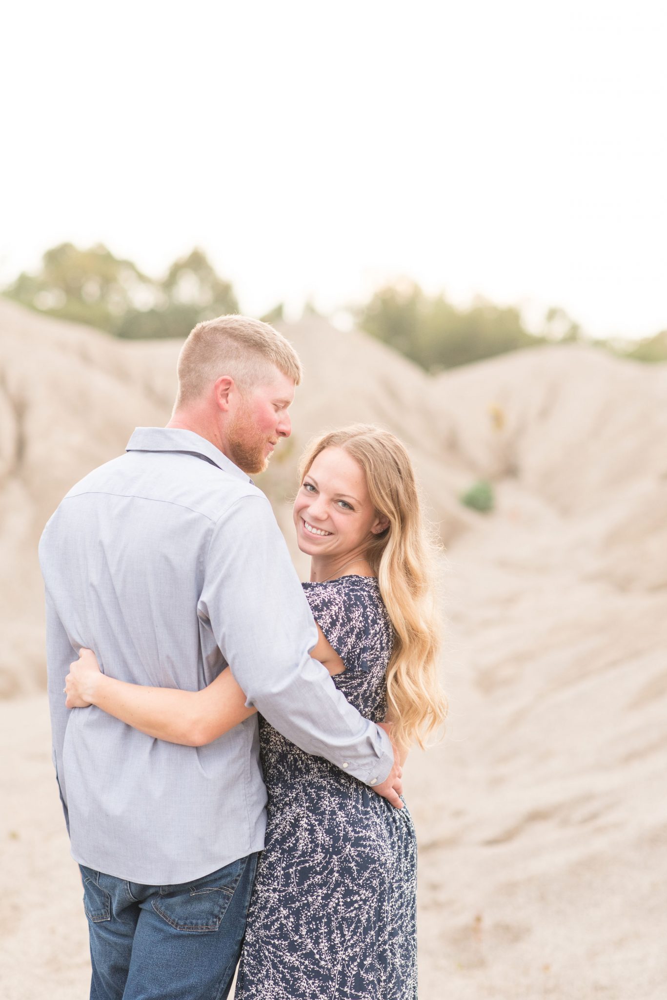 Couple hold on to each other in rock quarry by Indianapolis wedding photographer Victoria Rayburn Photography