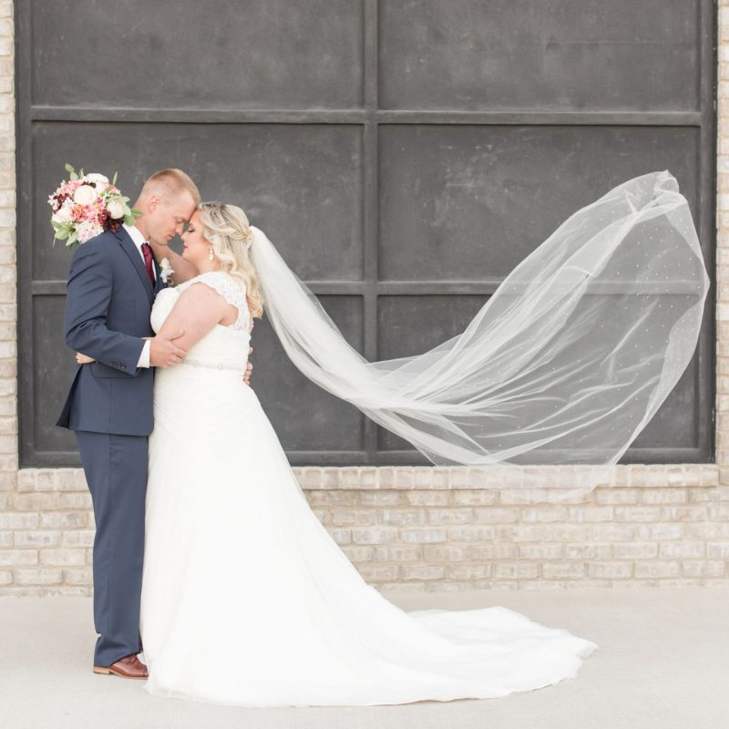 Bride and groom with blowing veil by Indianapolis wedding photographer Victoria Rayburn Photography