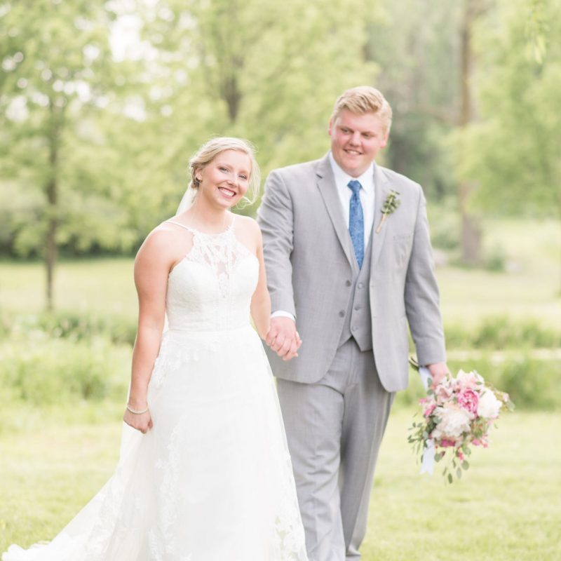 Bride and groom walk through park after wedding by Indianapolis wedding photographer Victoria Rayburn Photography