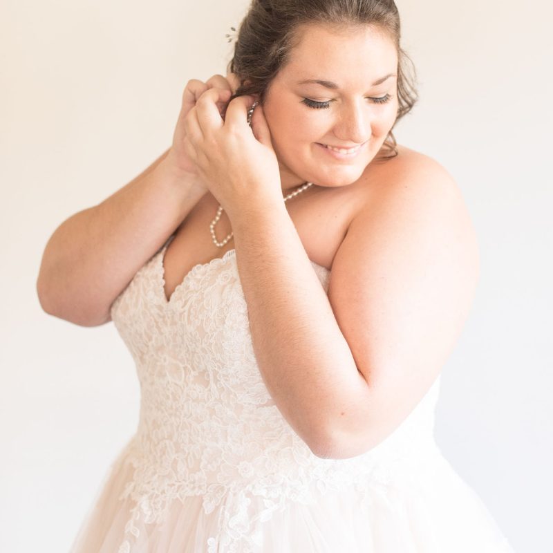 Bride putting on earring before wedding by Indianapolis wedding photographer Victoria Rayburn Photography