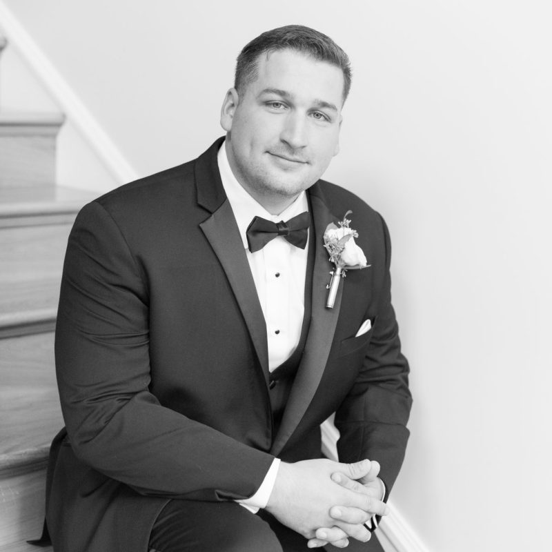 Groom on stairs before wedding by Indianapolis wedding photographer Victoria Rayburn Photography