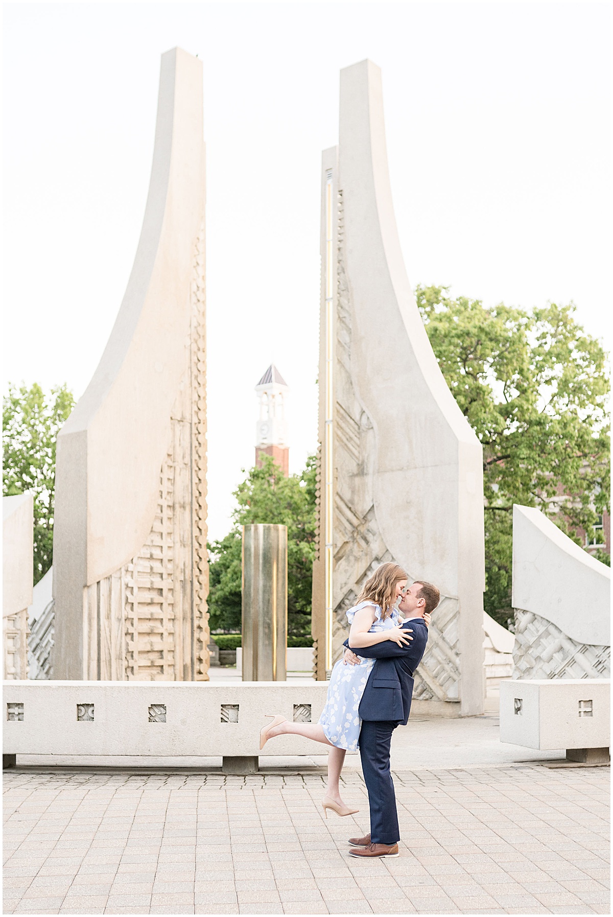 Couple hugging by Purdue Engineering Fountain during engagement photos by Indianapolis wedding photographer Victoria Rayburn Photography