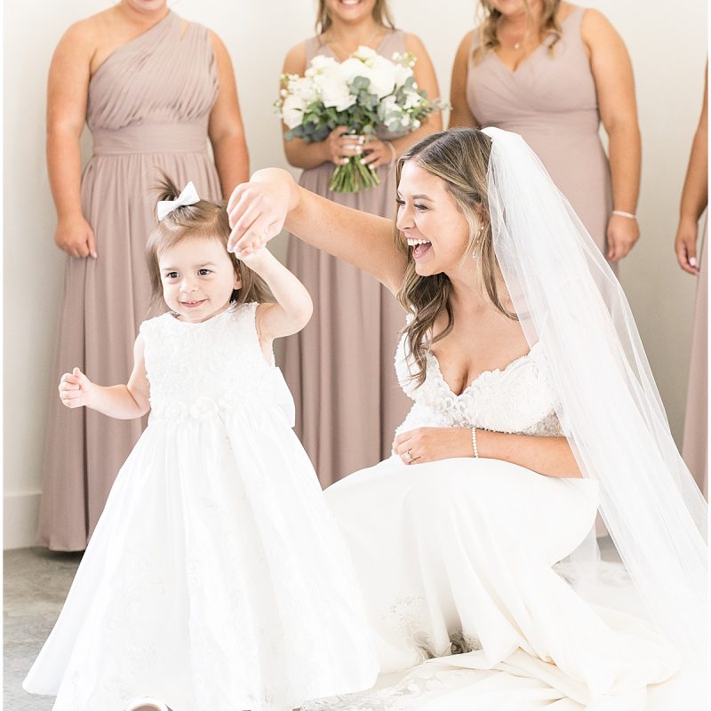 Bride twirls flower girl before New Journey Farms wedding by Indianapolis wedding photographer Victoria Rayburn Photography