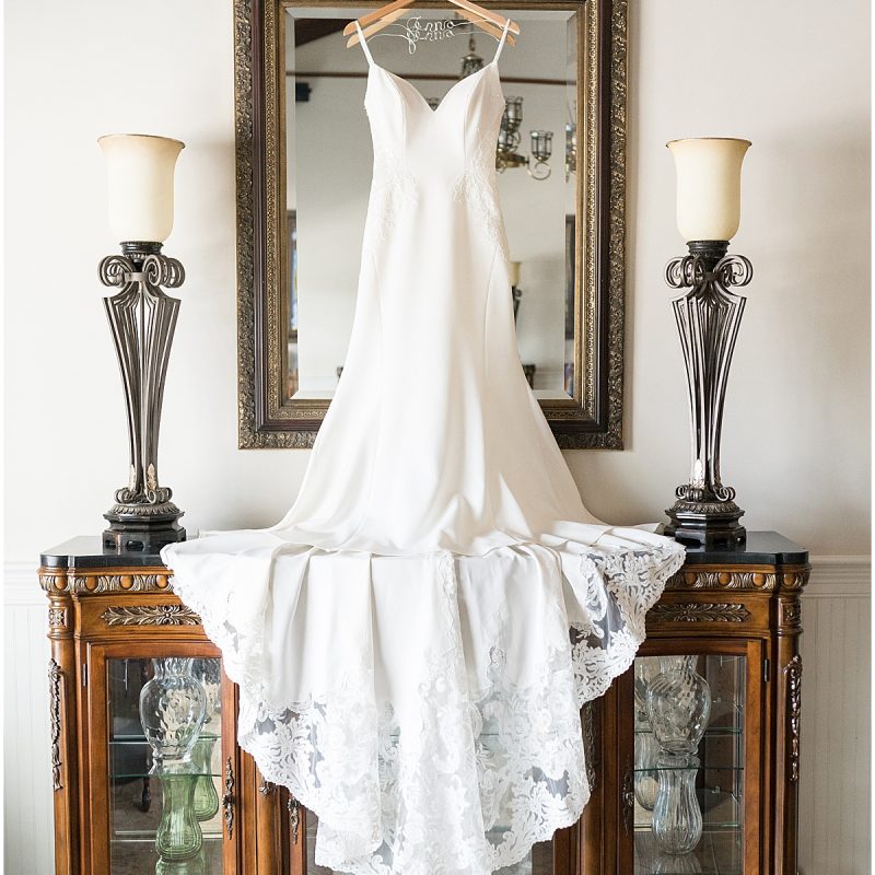 Wedding gown hanging on mirror ready for wedding by Indianapolis wedding photographer Victoria Rayburn Photography