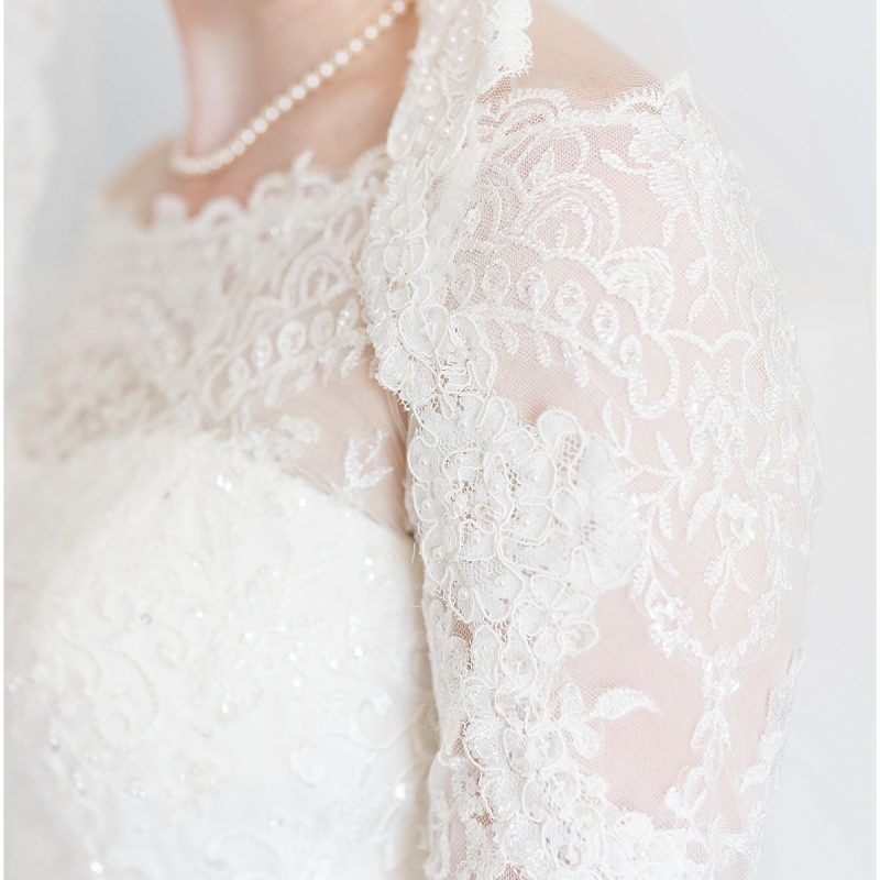 Detail of floral lace on bride's arm during brides portraits by Indianapolis wedding photographer Victoria Rayburn Photography