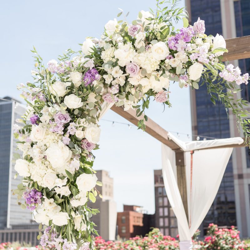Purple and white wedding arch flowers for downtown wedding by Indianapolis wedding photographer Victoria Rayburn Photography