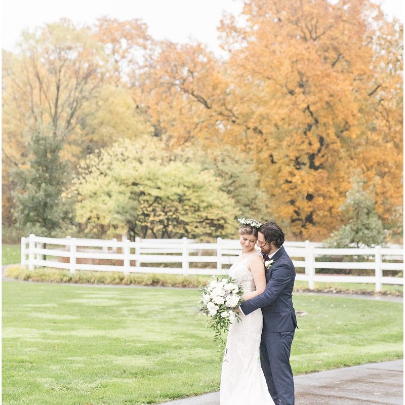 Bride and groom in front of fall colored leaves during wedding photos by Indianapolis wedding photographer Victoria Rayburn Photography