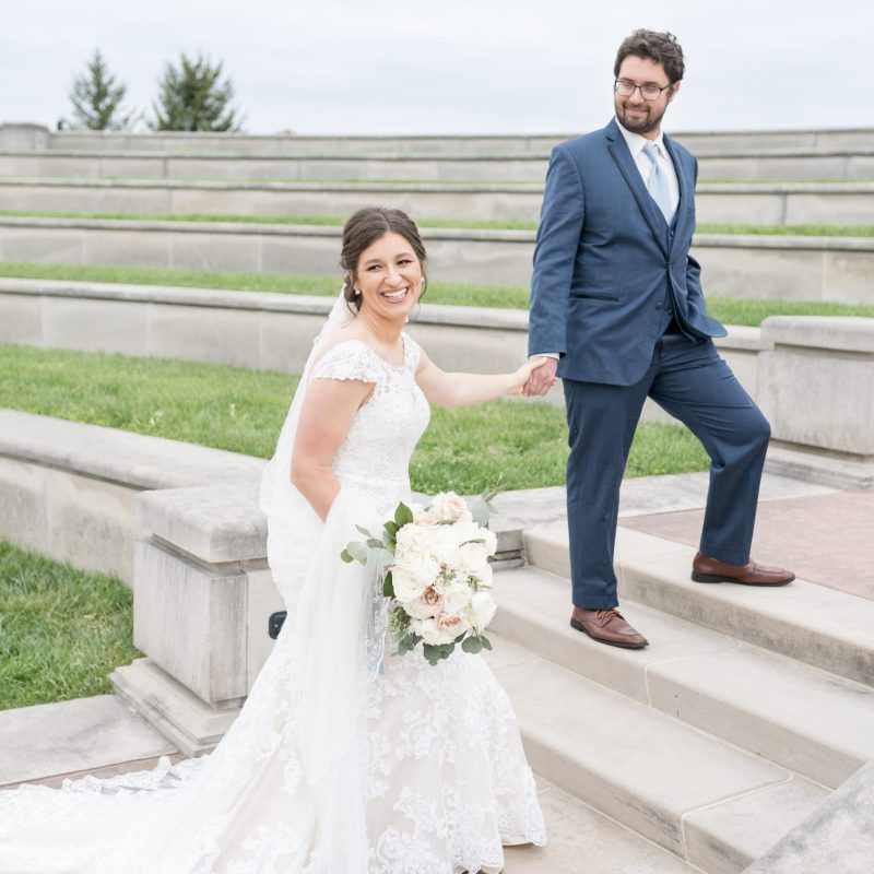 Bride and groom walking up steps at Coxhall gardens during wedding photos by Indianapolis wedding photographer Victoria Rayburn Photography