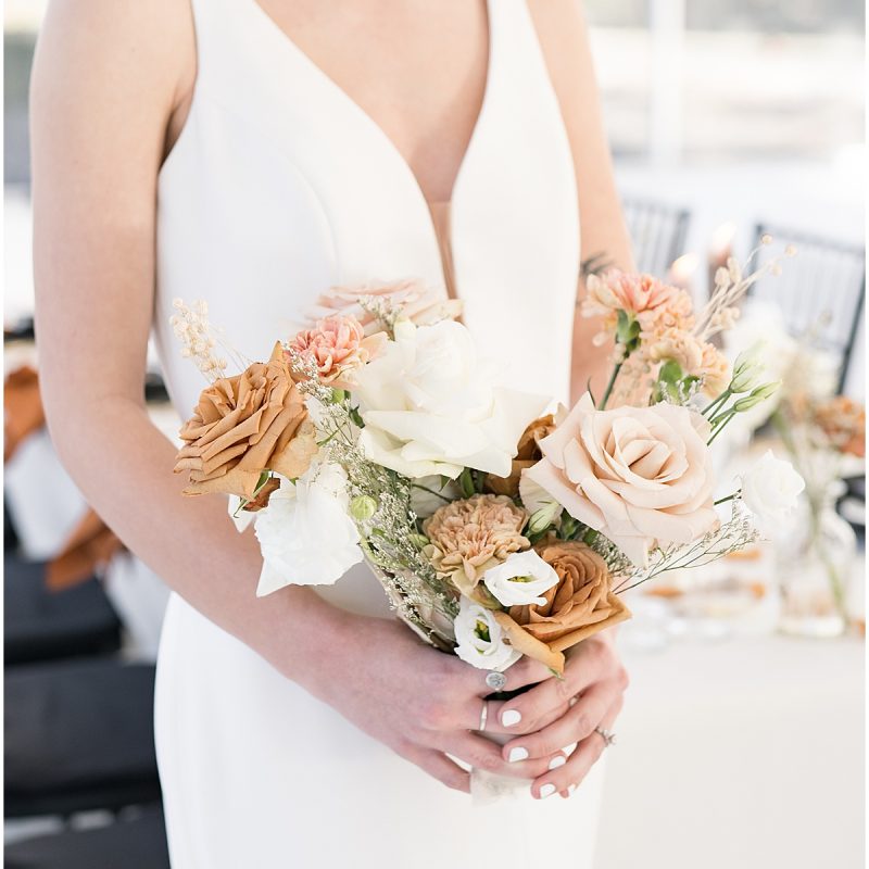 Bride holding fall themed bouquet during bridal portraits by Indianapolis wedding photographer Victoria Rayburn Photography