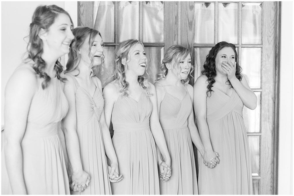 Bride first look with bridesmaids before wedding at The Matterhorn in Elkhart, Indiana