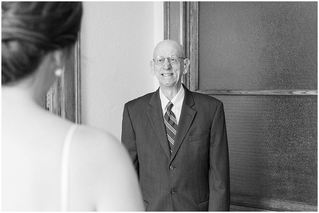 Bride first look with father at Spohn Ballroom wedding in Goshen, Indiana