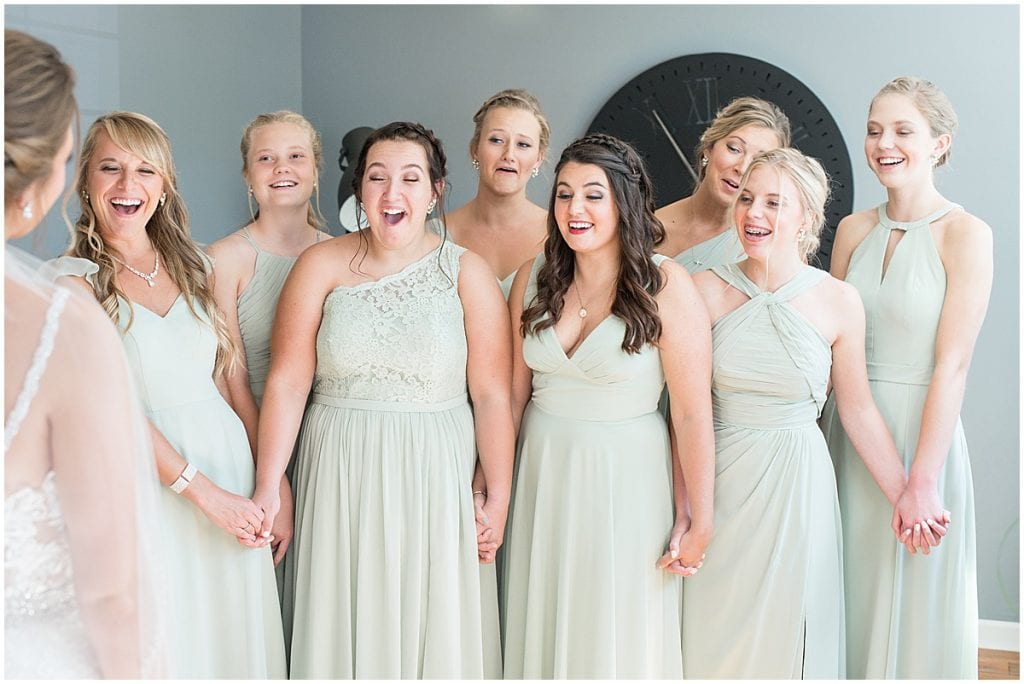 Bridesmaids react to bride before her ceremony at Trinity United Methodist Church in Rensselaer, Indiana.