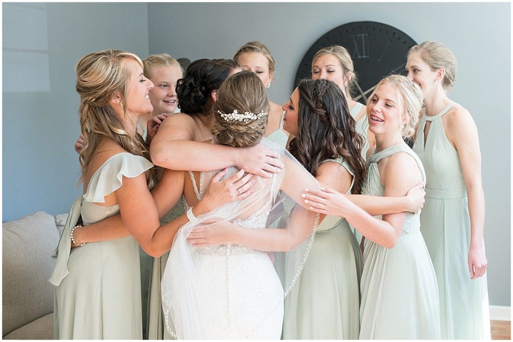 Bridesmaids react to bride before her ceremony at Trinity United Methodist Church in Rensselaer, Indiana.