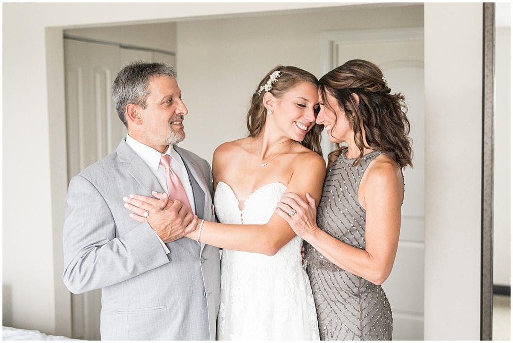 Parents of the bride embracing last moments with bride before her wedding in Cedar Lake, Indiana
