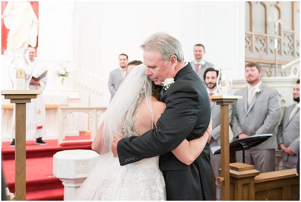Bride giving father hug at wedding at St. John Lutheran Church in Indianapolis