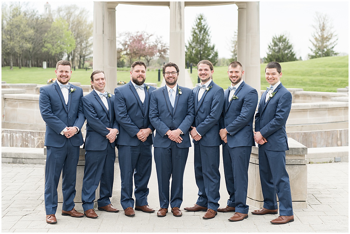Groom with groomsmen at bridal party photos at Coxhall Gardens in Carmel, Indiana