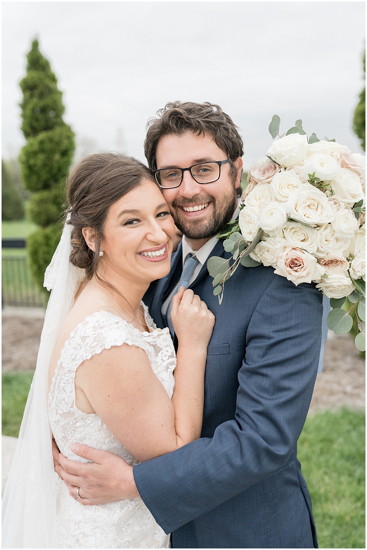 Couple with white bouquet at Coxhall Gardens in Carmel, Indiana