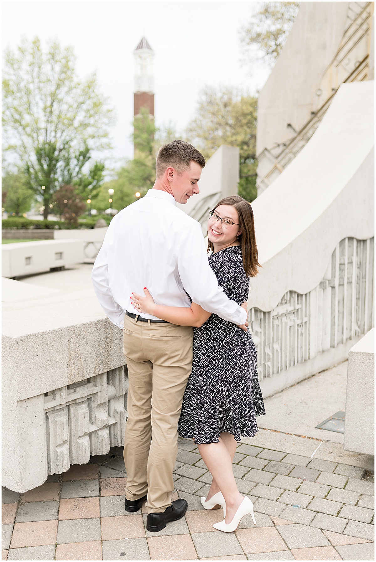 Couple hugging during engagement and graduation photos at Purdue University by Purdue's Engineering Fountain