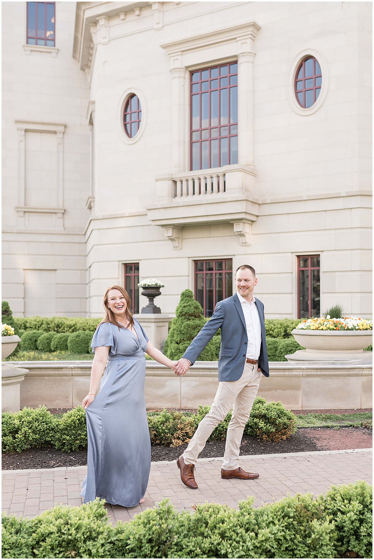 Couple walking on path during engagement photos at The Palladium in Carmel, Indiana