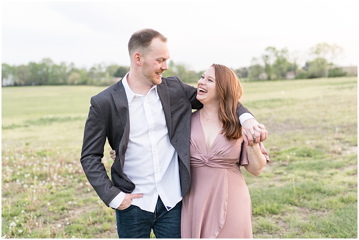 Couple laughing together during engagement photos at Urban Vines in Carmel, Indiana