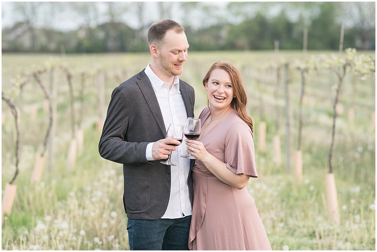 Couple enjoys wine during engagement photos at Urban Vines in Carmel, Indiana