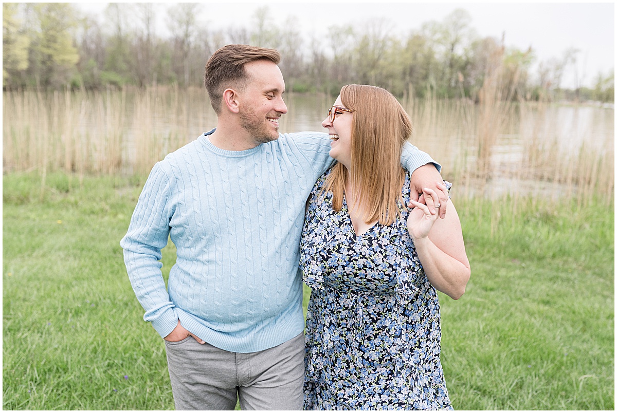 Couple laughing during engagement photos at Wildcat Creek Reservoir Park in Kokomo, Indiana