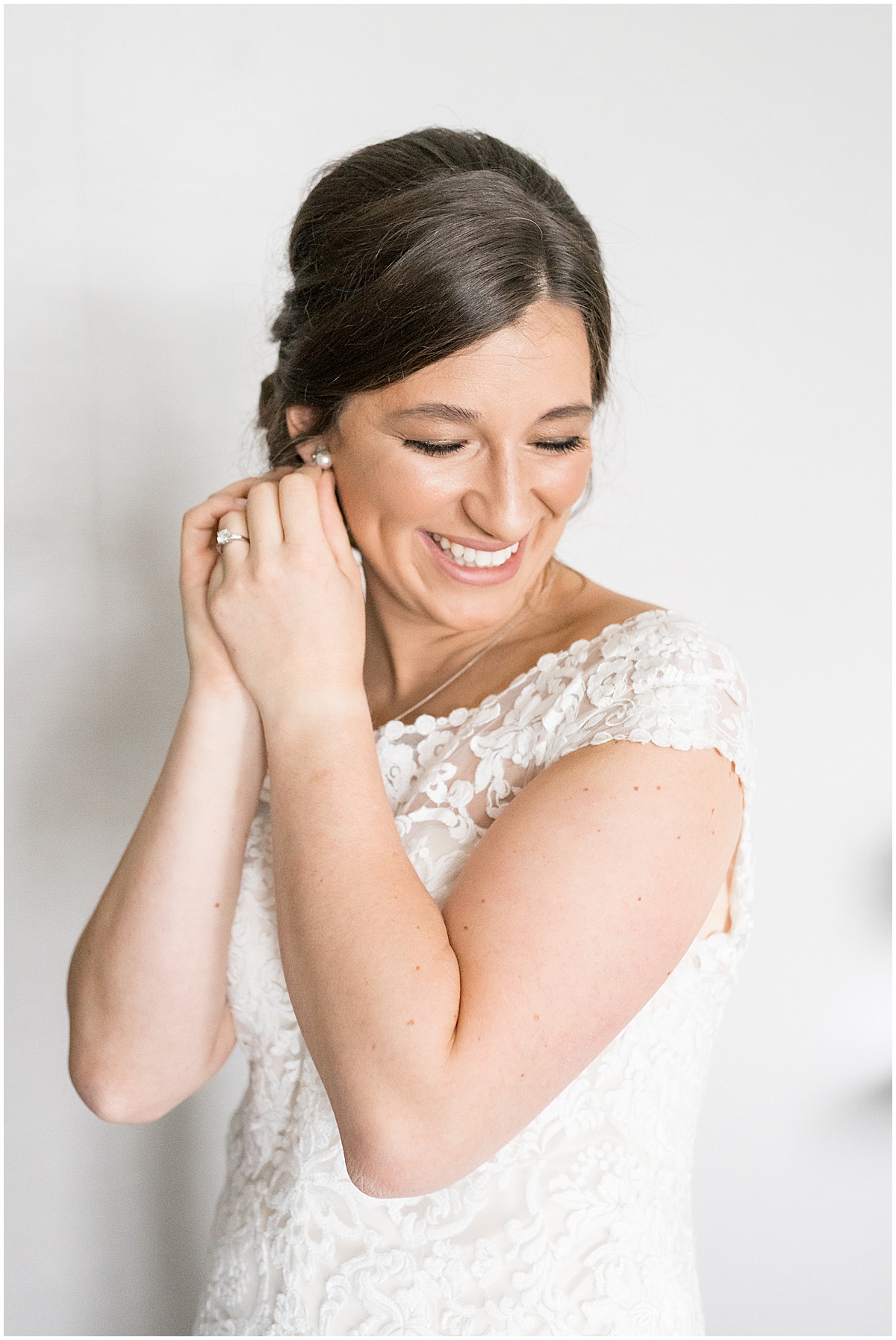 Bride putting on earrings at Marriott North Indianapolis