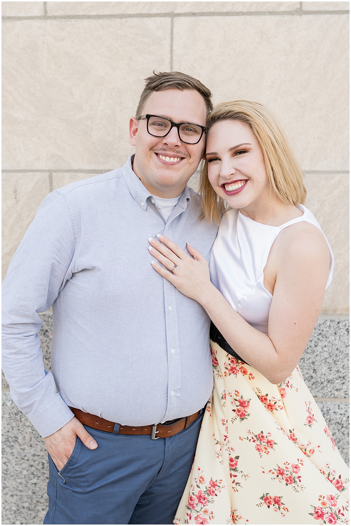 Couple hugging at spring engagement photos in Downtown Lafayette, Indiana