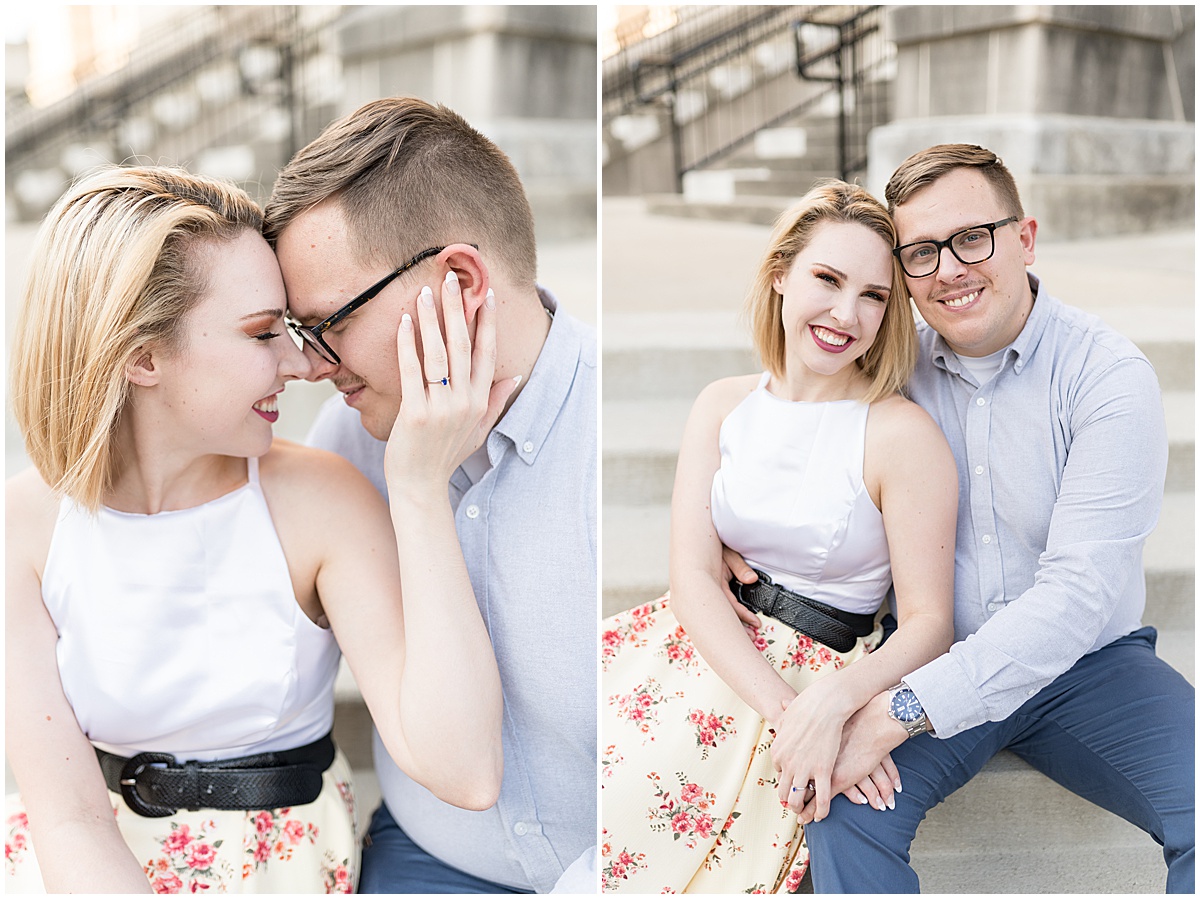 Couple sitting on steps during spring engagement photos in Downtown Lafayette, Indiana