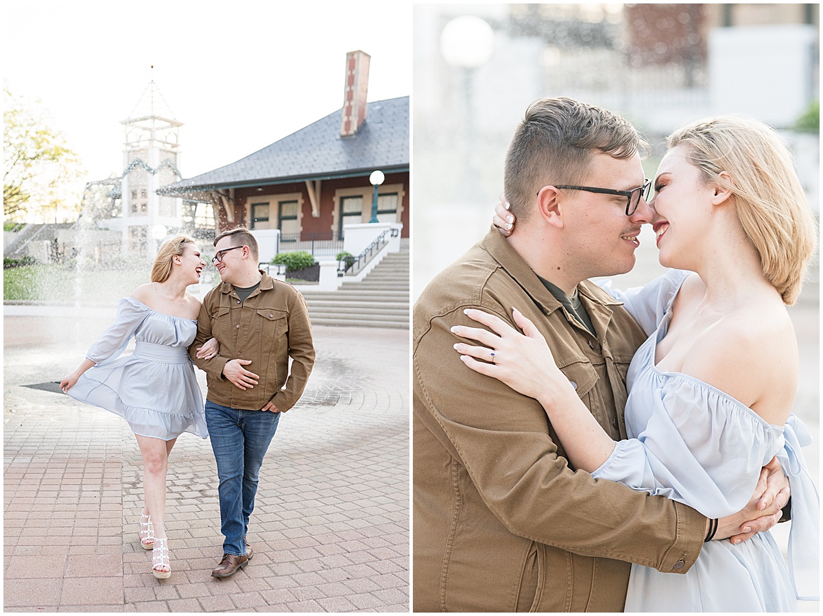 Couple kissing in front of fountain during spring engagement photos in Downtown Lafayette, Indiana