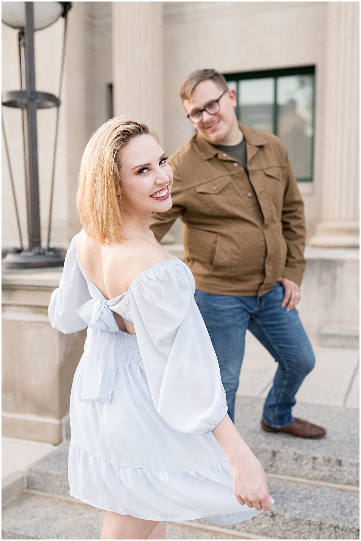 Couple laughing during engagement photos in Downtown Lafayette, Indiana by the Tippecanoe Arts Federation