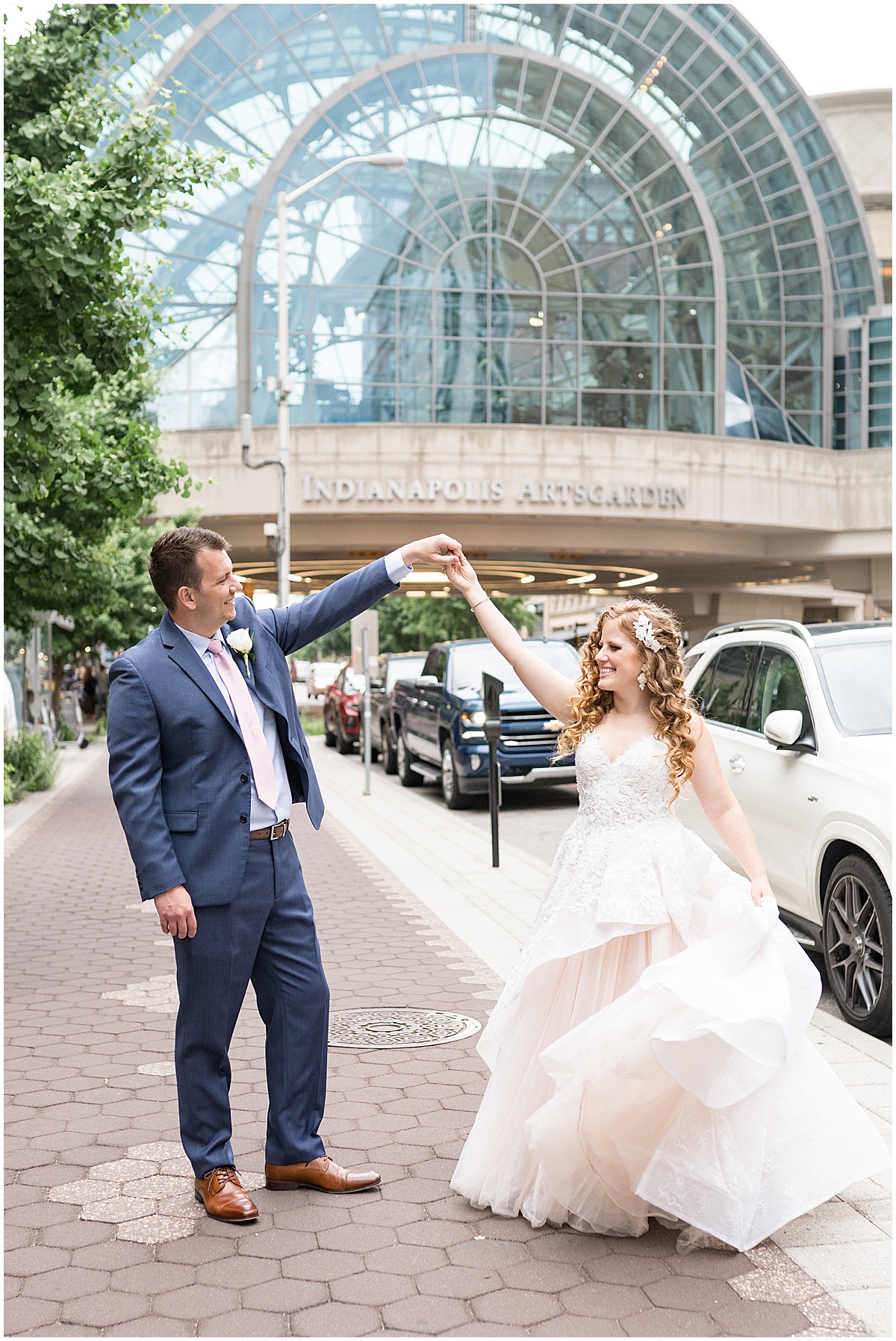 Bride and groom dancing outside of Indianapolis Artsgarden in downtown Indianapolis