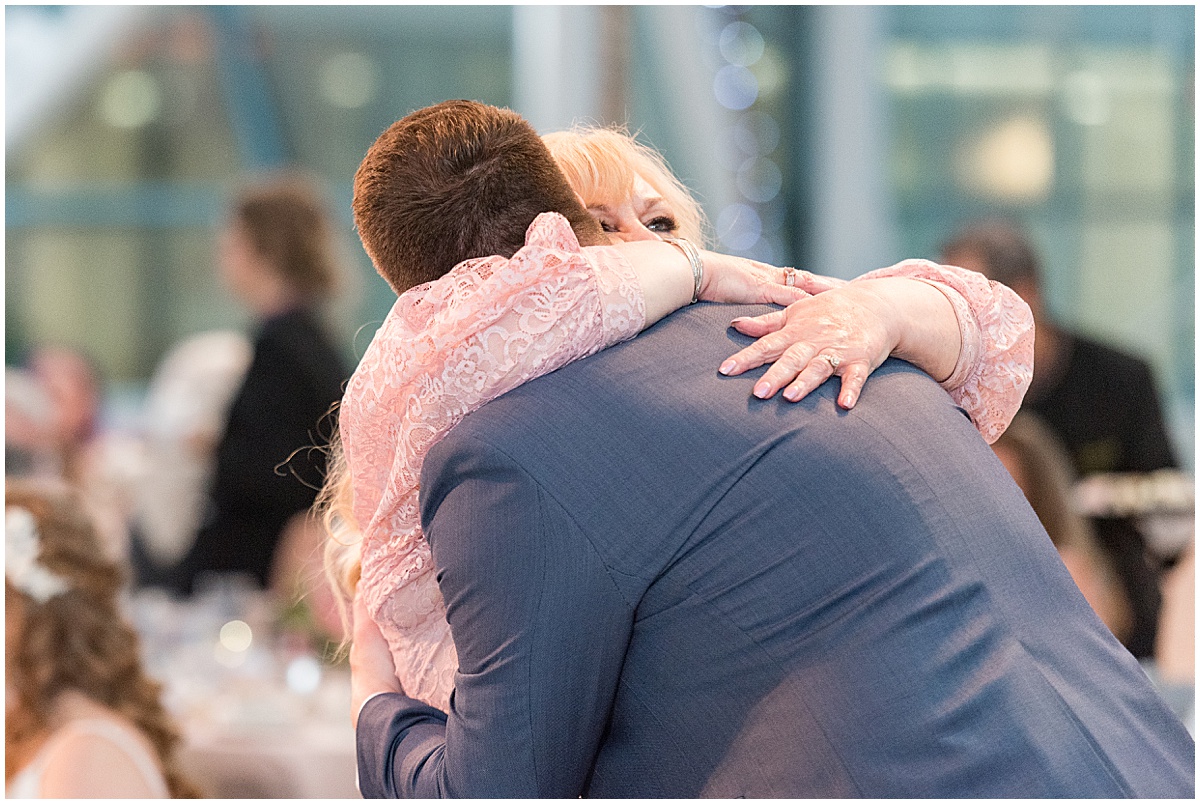 Groom and mother hugging at Indianapolis Artsgarden wedding reception