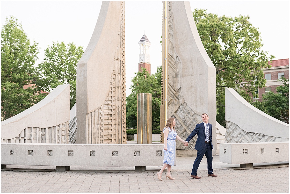 Couple walking by fountain at Purdue engagement photos