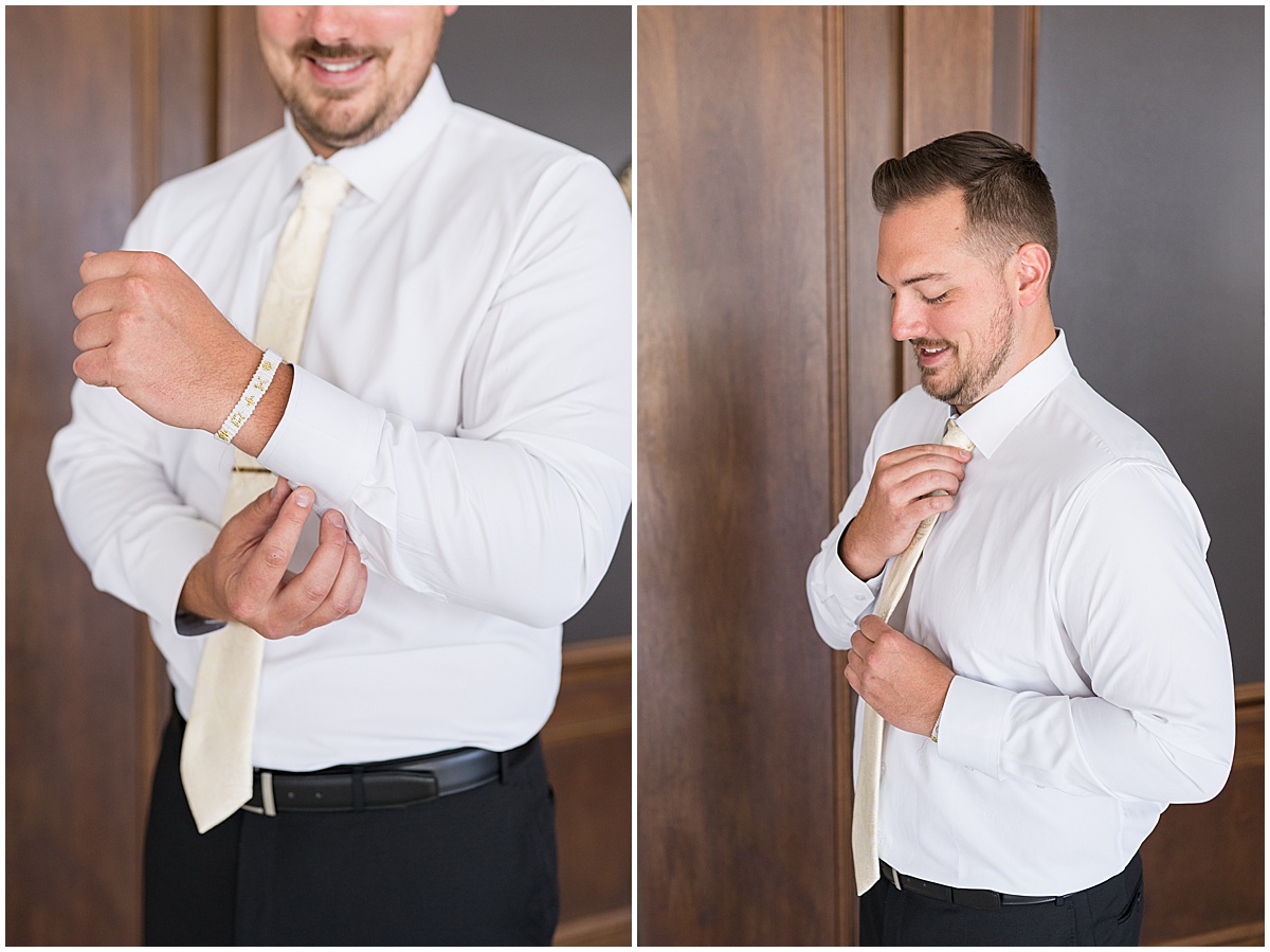 Groom putting on tie and cuff links for wedding at JPS Events in downtown Indianapolis.