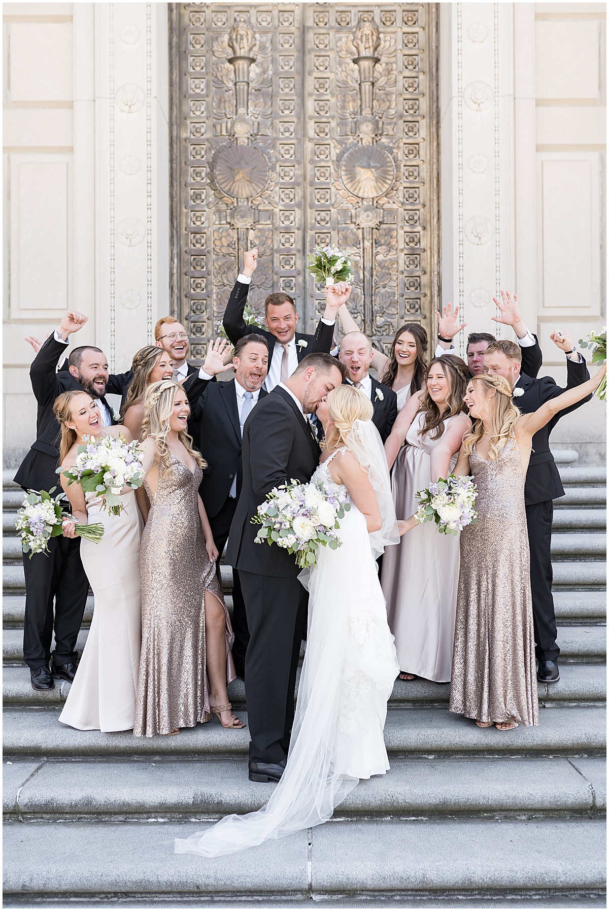 Bridal party celebrate at The Indiana War Memorial in downtown Indianapolis.