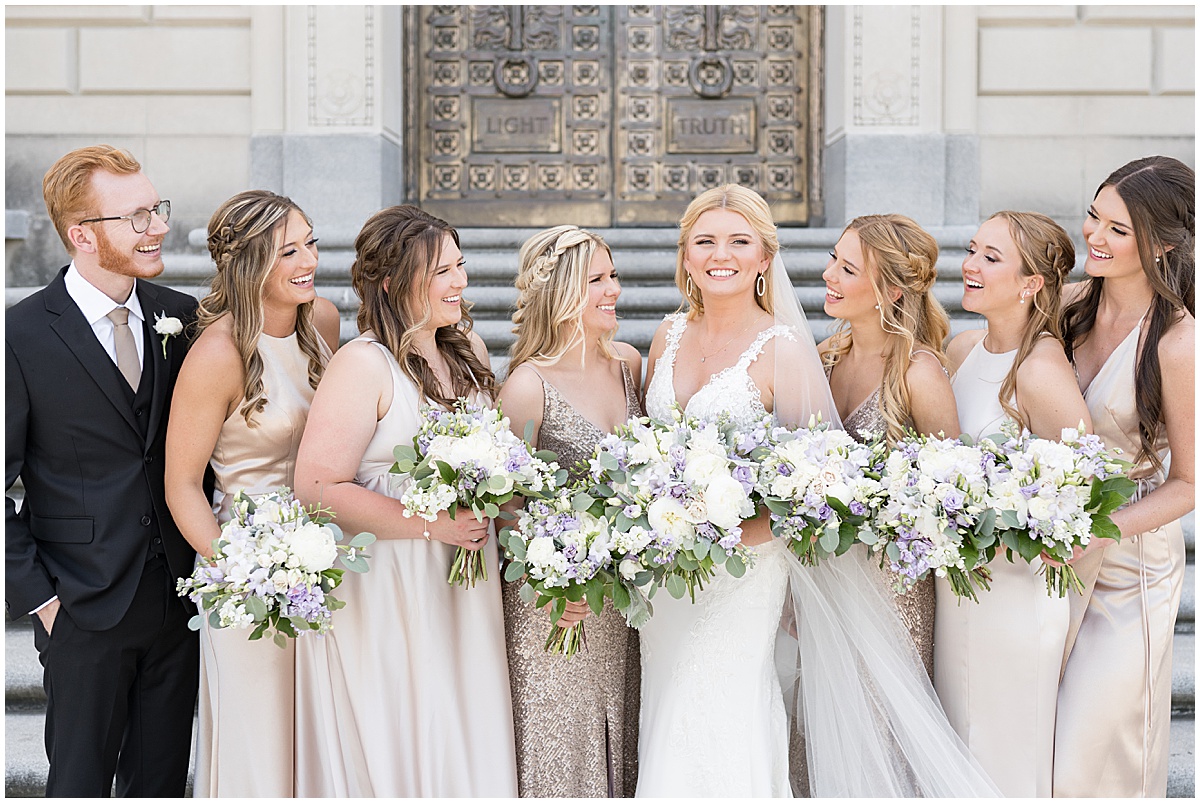 Bride with Bridesmaids by gold door at The Indiana War Memorial in downtown Indianapolis.