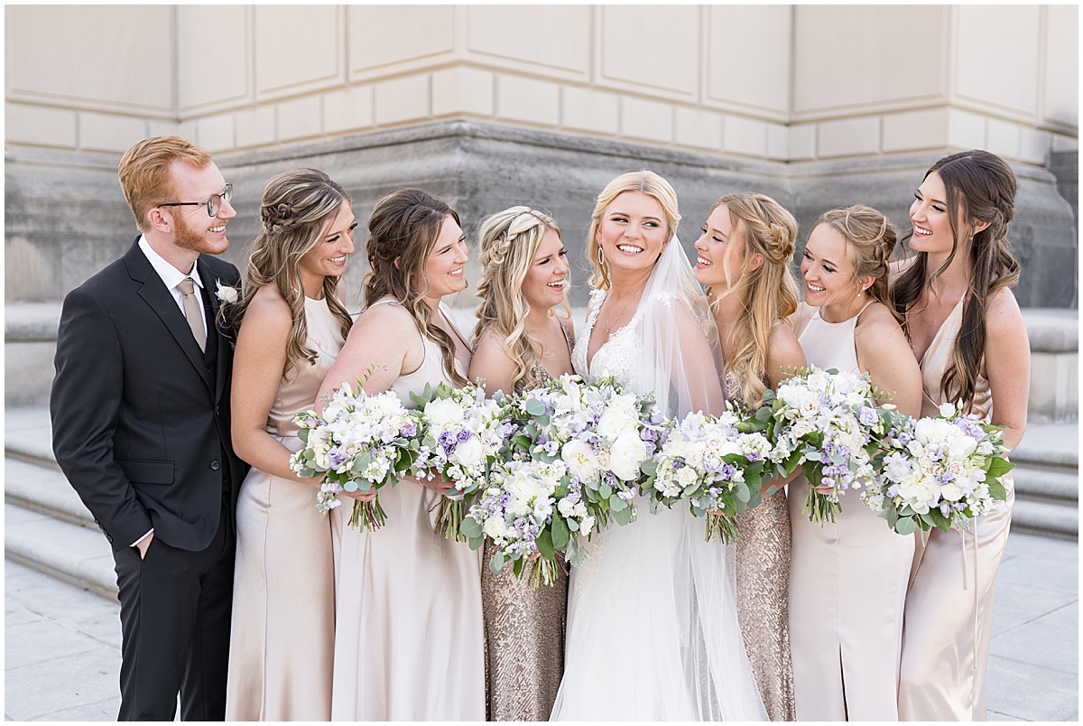 Bride laughing with bridesmaids at The Indiana War Memorial in downtown Indianapolis.