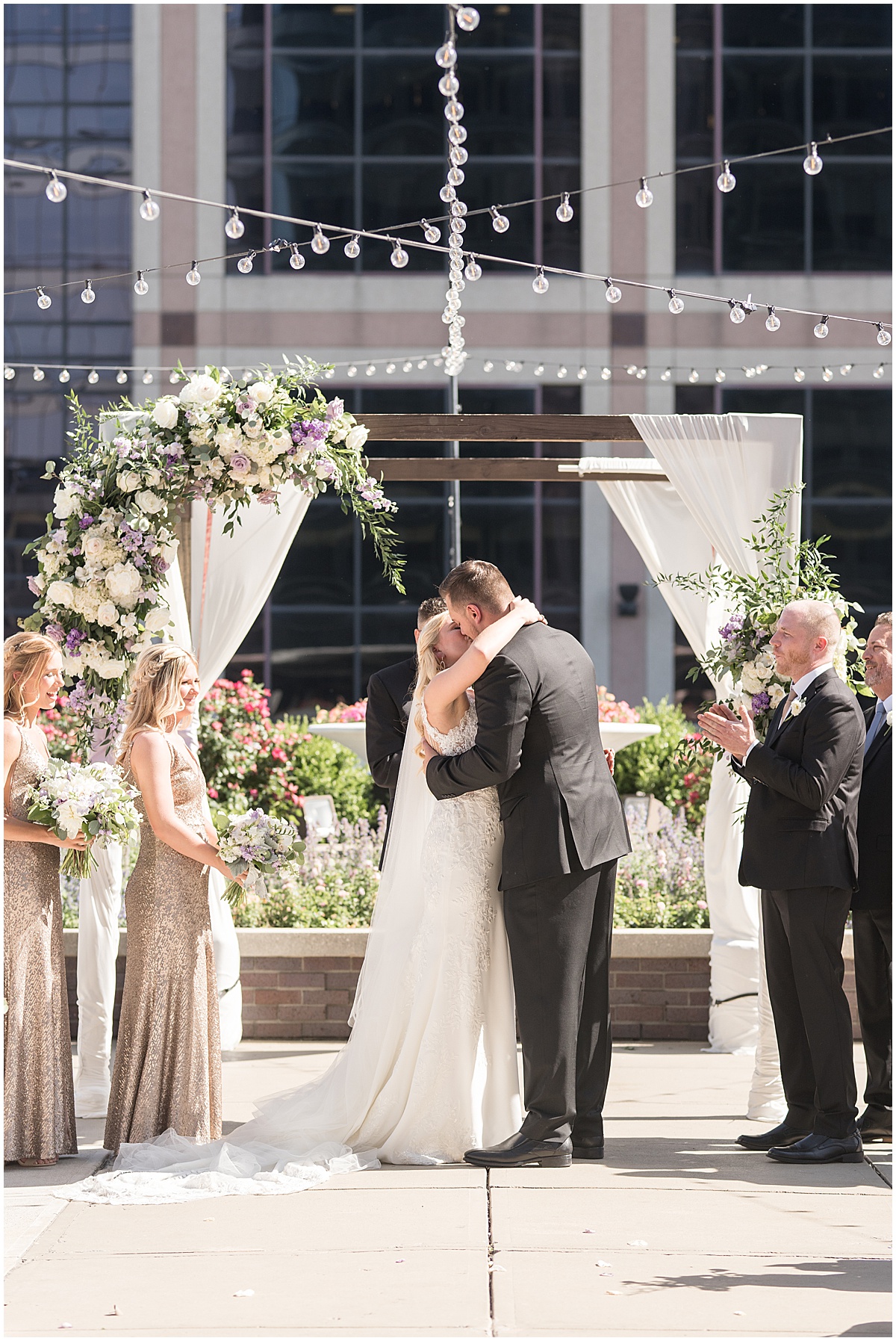 Bride and groom kiss at rooftop wedding in downtown Indianapolis at JPS Events