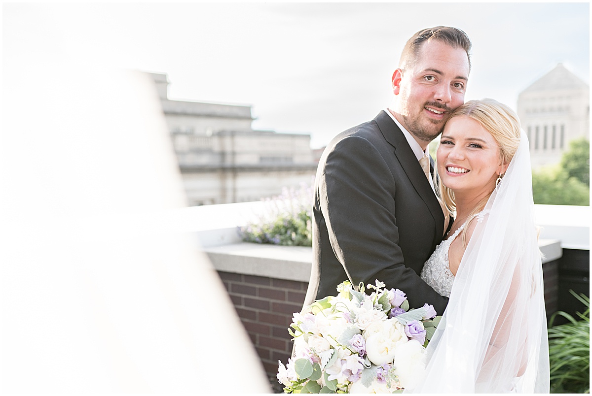 Bride and groom hug after rooftop wedding in downtown Indianapolis at JPS Events