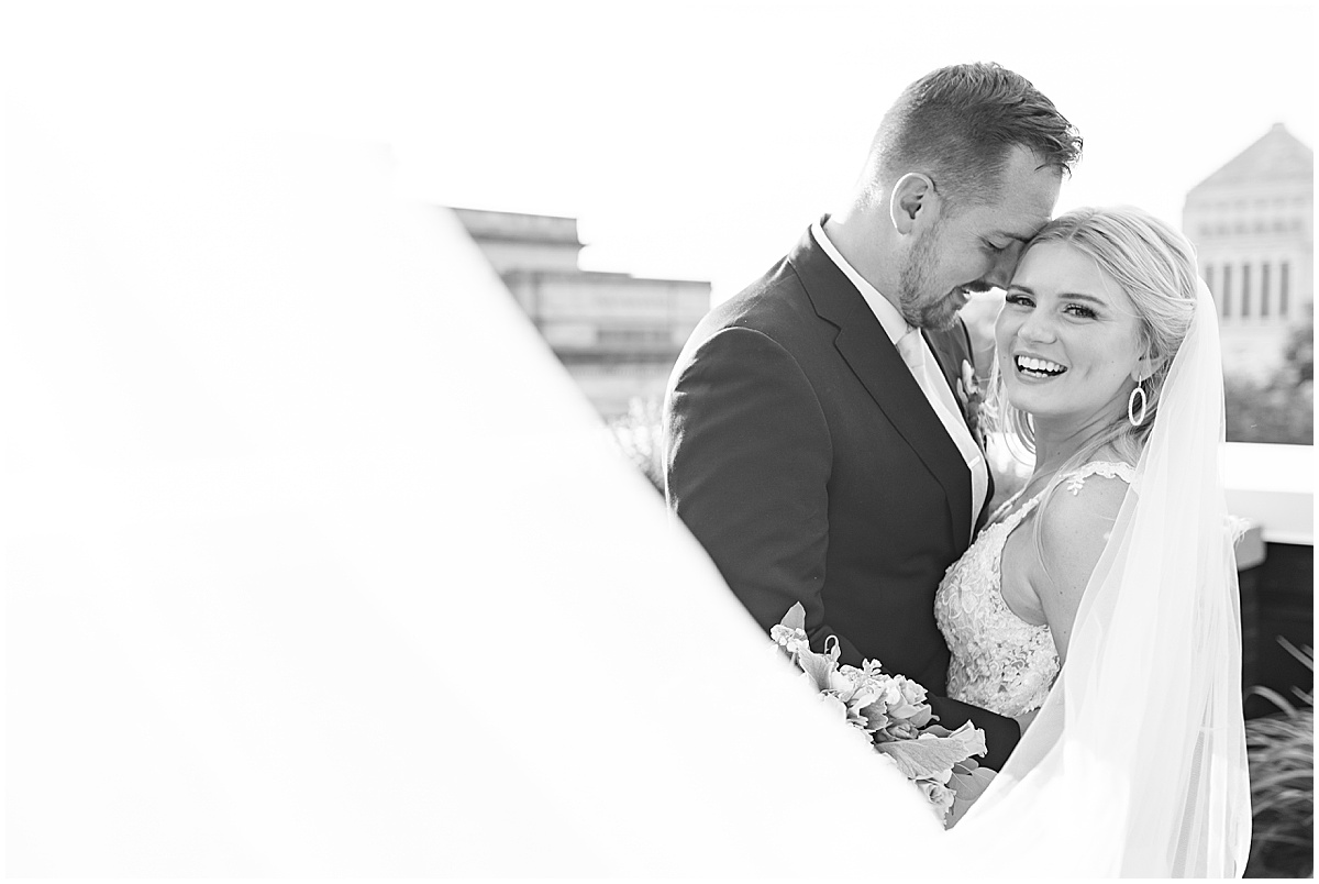 Bride and groom laughing after rooftop wedding in downtown Indianapolis at JPS Events