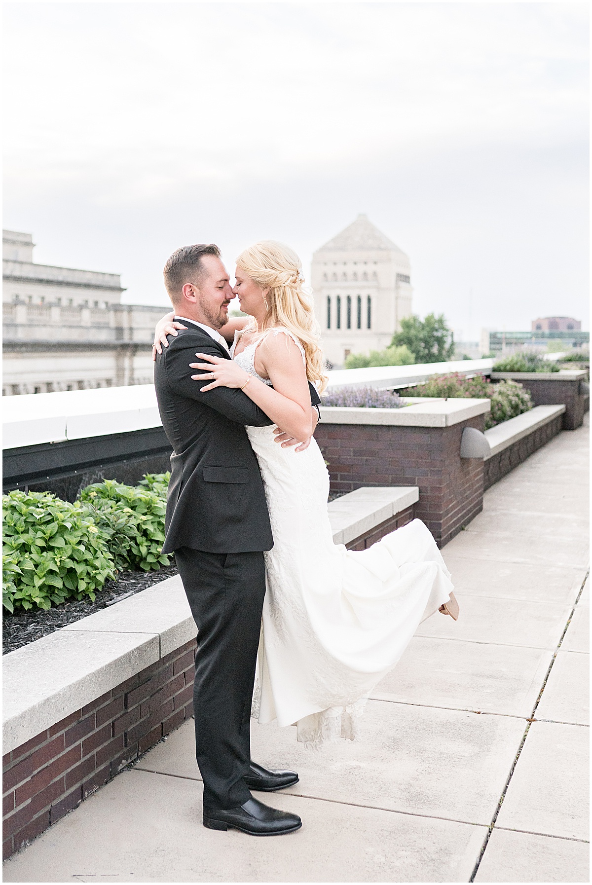 Groom picks up bride at rooftop wedding in downtown Indianapolis at JPS Events