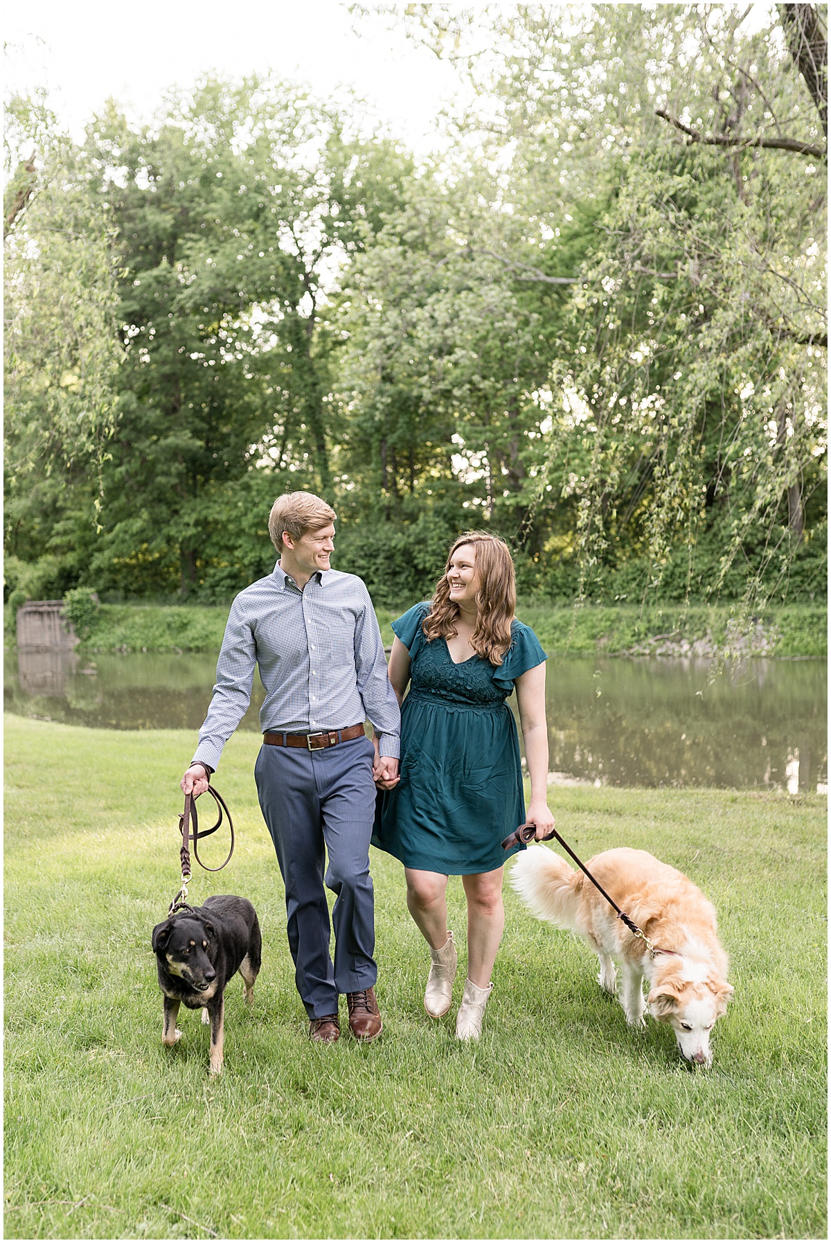 Couple walking dogs together at spring engagement photos at Holcomb Gardens in Indianapolis