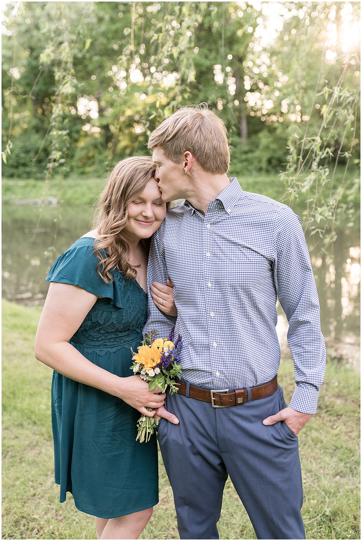 Groom to be kissing finance during spring engagement photos at Holcomb Gardens in Indianapolis