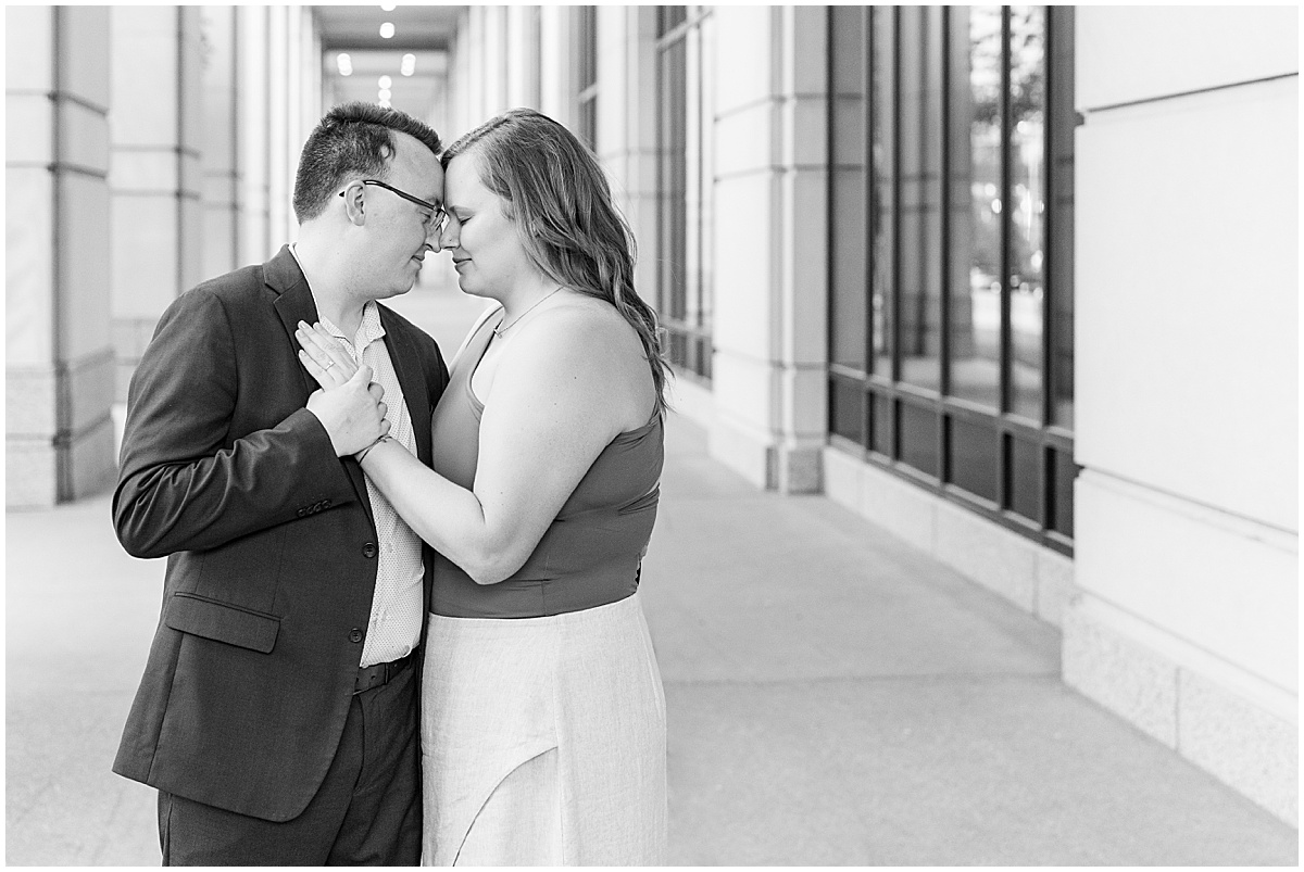 Couple enjoying quiet moment during engagement photos in downtown Indianapolis by the Indiana Government Center.