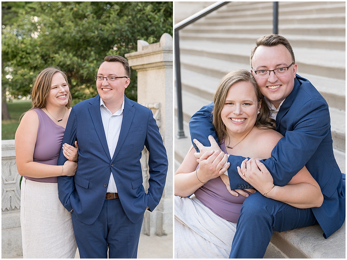 Couple hugging each other during engagement photos in downtown Indianapolis by the Indiana State Capitol Building.