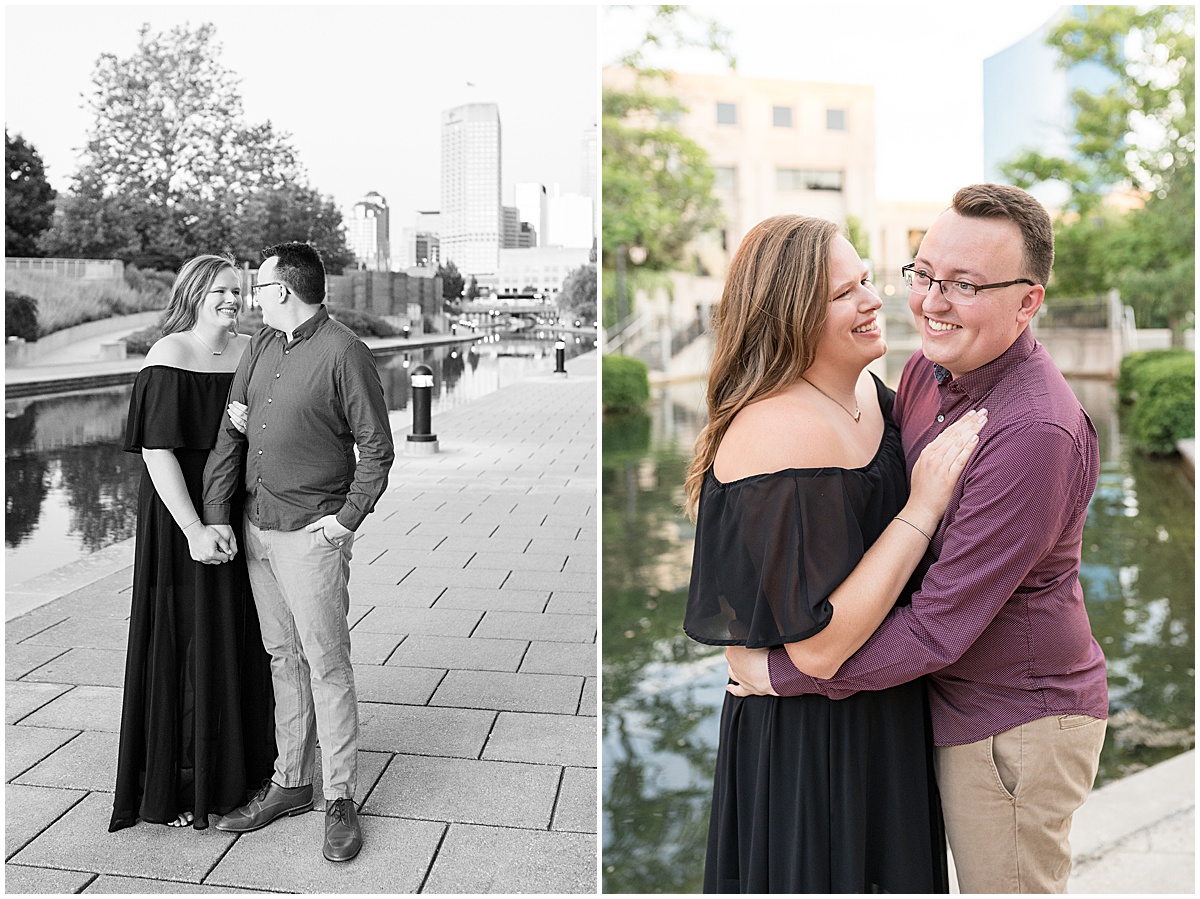Couple laughing by water at downtown Indianapolis Canal Walk engagement photos.