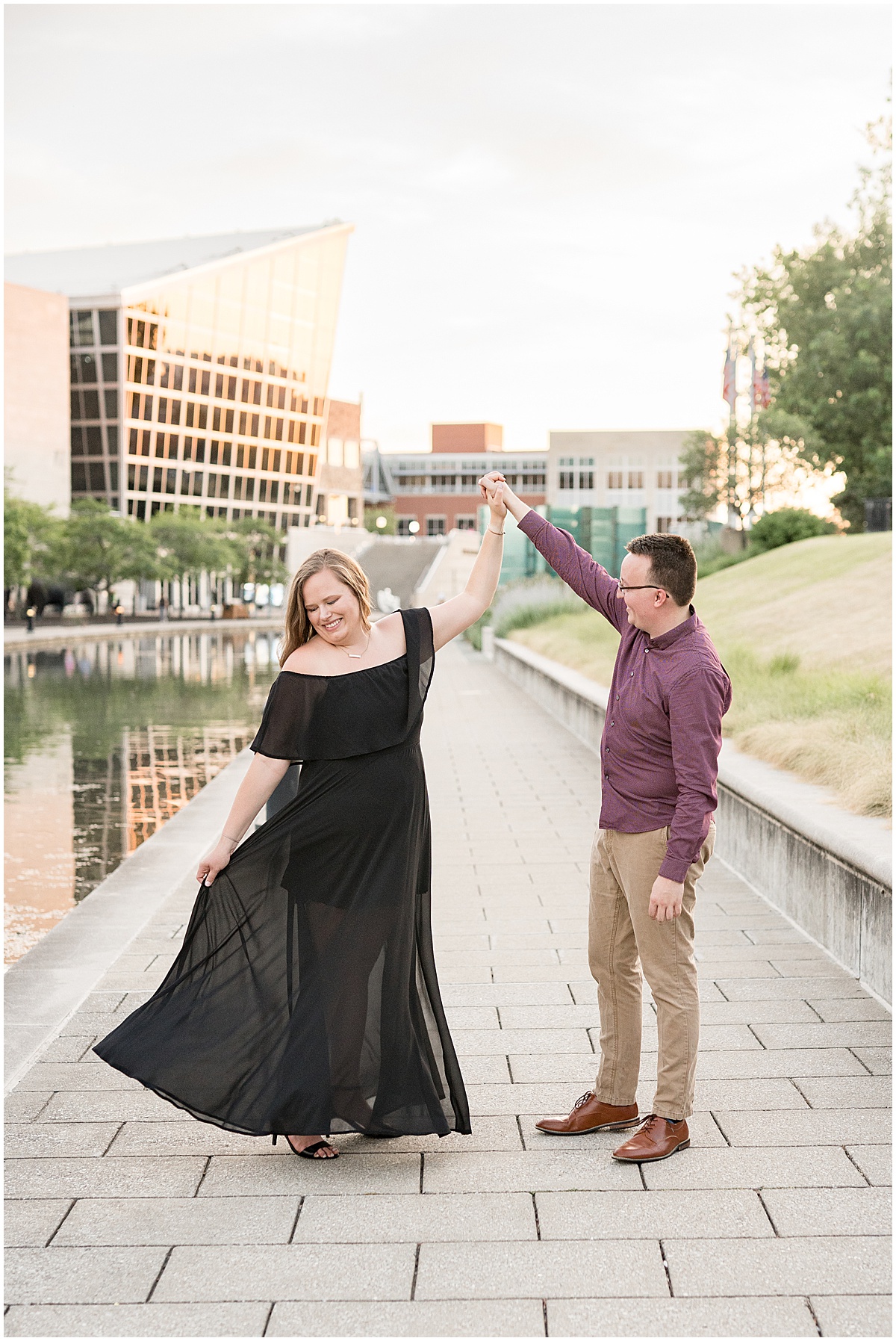 Couple dancing during downtown Indianapolis Canal Walk engagement photos.