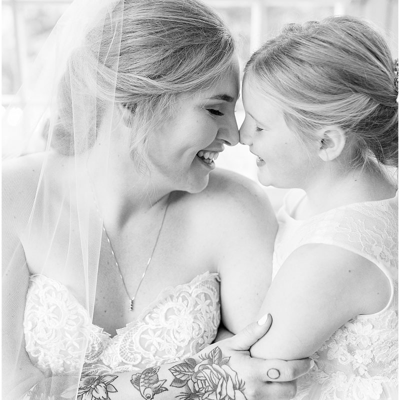 Bride and daughter get close at Fowler House Mansion wedding